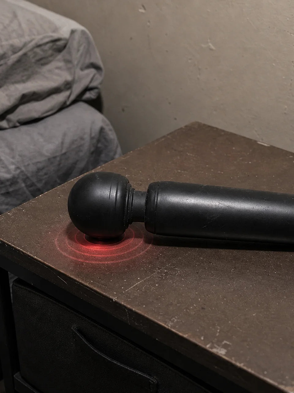 Ordinary black wand vibrator on a bedside table suggesting a blunt one-note feel