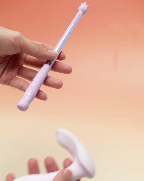 Two people holding the Violet Spell Wand and Pearl without a phone