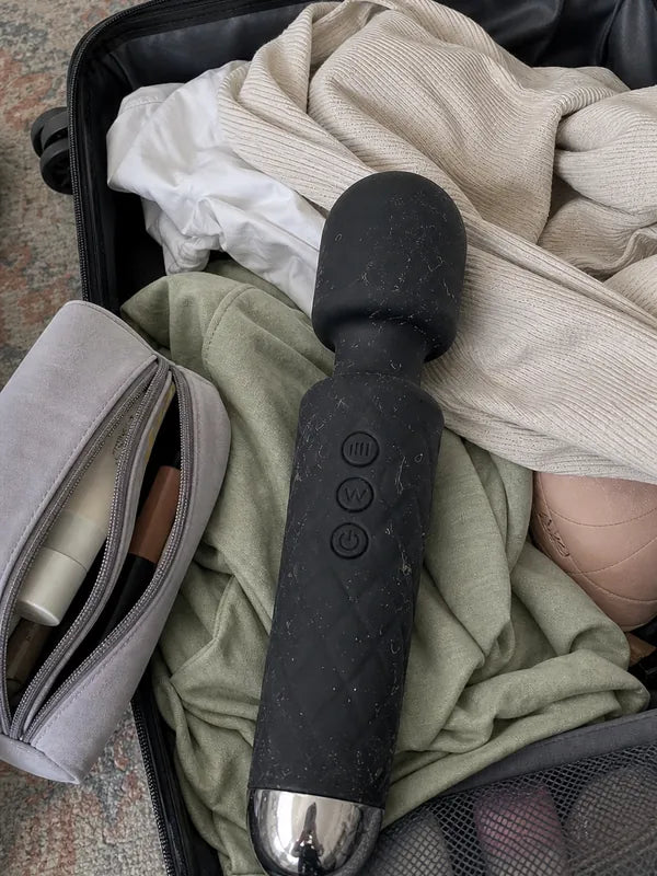 Bulky black wand vibrator taking up space in a suitcase